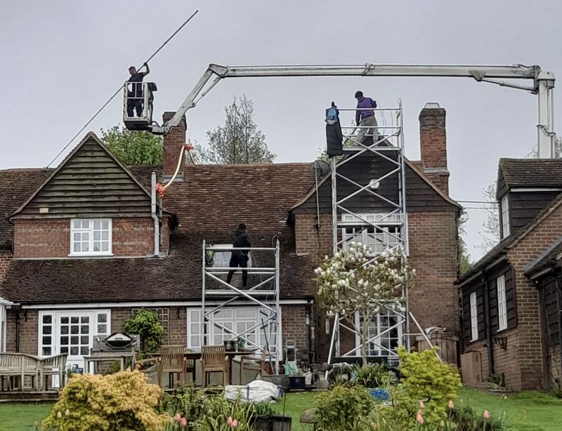 The Roof Moss Cleaners using cherry picker and scaffolding to clean roof safely and professionally in Kings Worthy, Hampshire